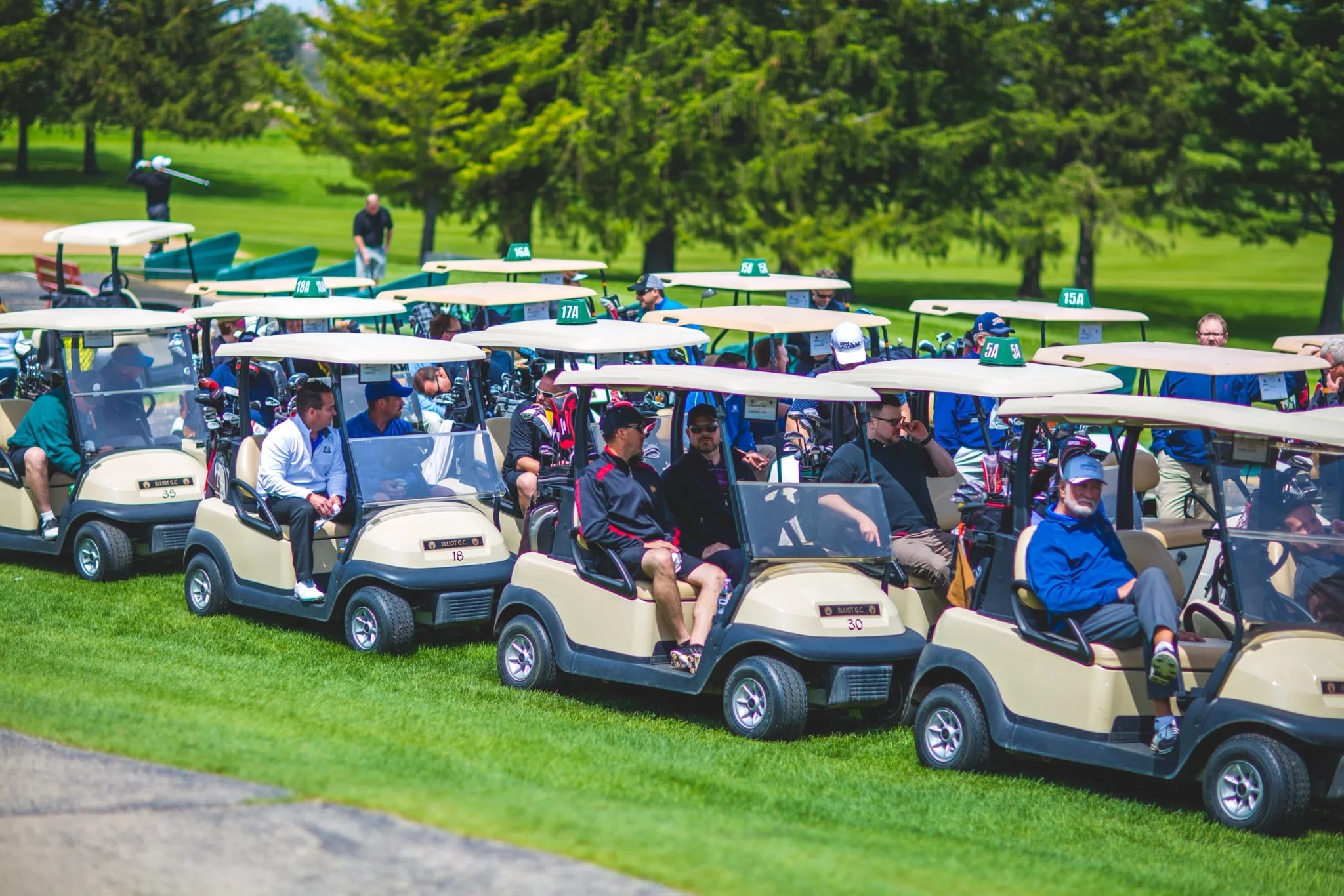 Golf carts lined up on the course for a shotgun start